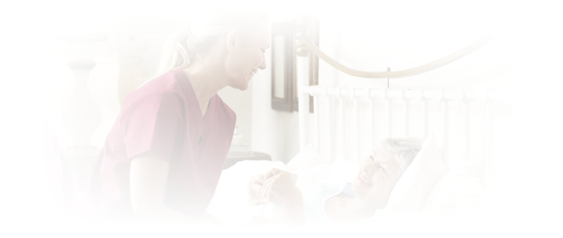 caregiver taking care of senior woman in bed